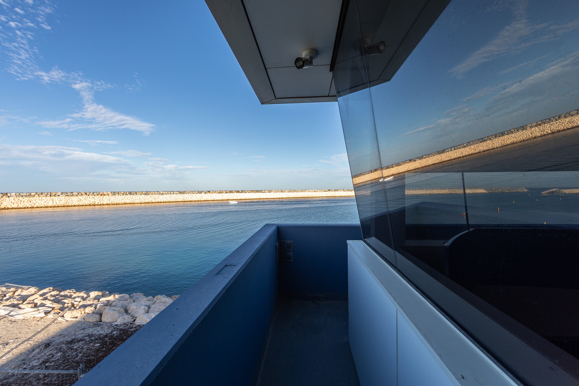 Balcony view from the Marine Rescue Whitfords building overlooking Ocean Reef Marina, breakwater and calm coastal waters.